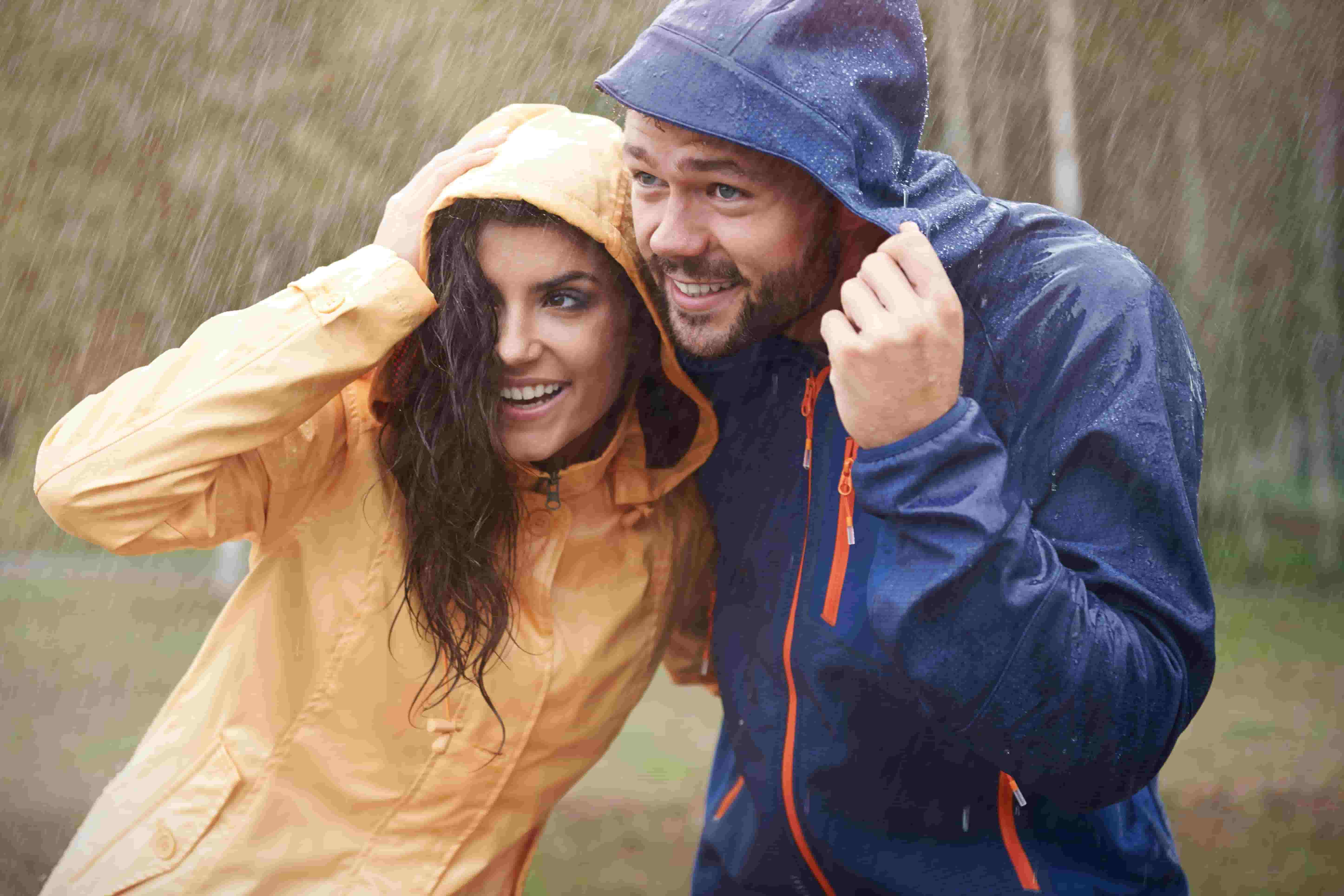 A man and a woman are enjoying the rain in our rain jackets