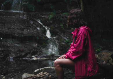 a girl is enjoying waterfall view 